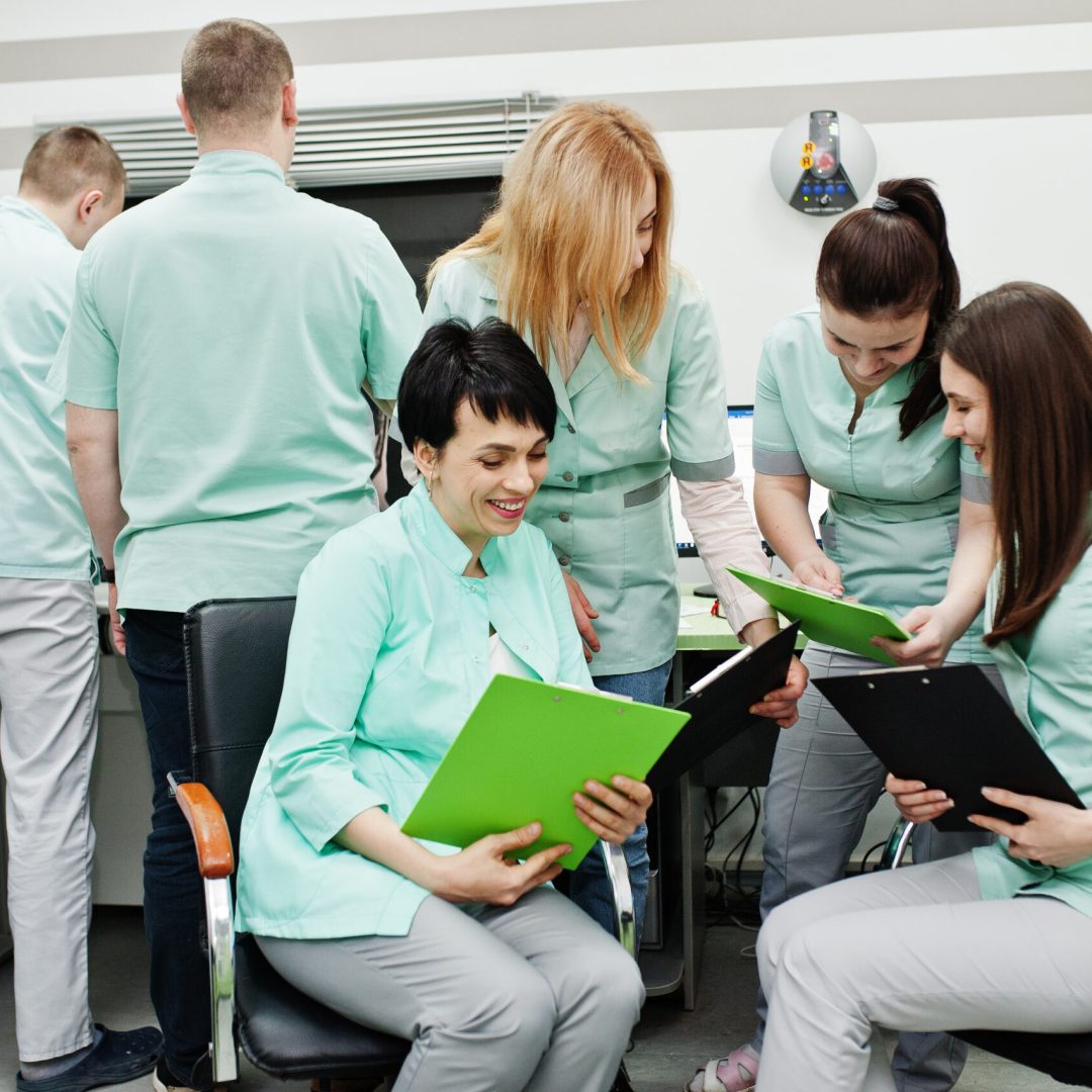 Medical theme.Observation room with a computer tomograph. The group of female doctors with clipboards meeting in the mri office at diagnostic center in hospital.